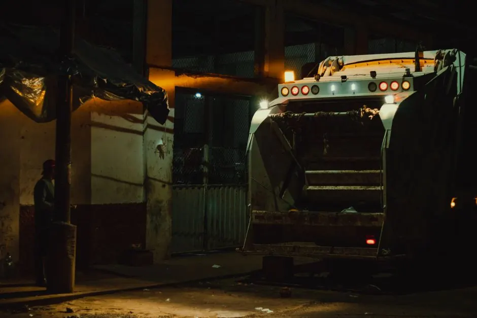 Garbage truck at night under city lights in Yurimaguas, Peru.